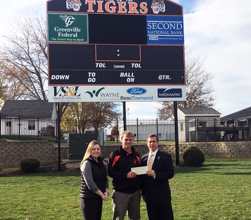 Greenville Federal gives donation for Versailles scoreboard